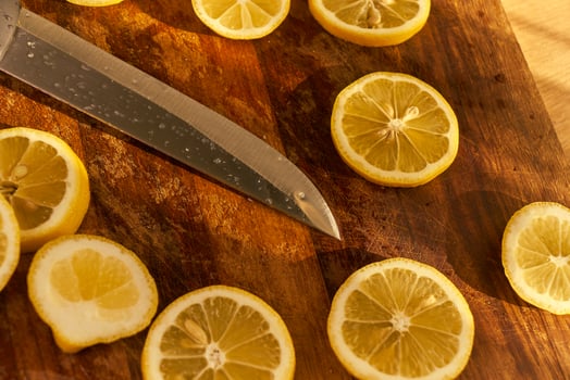 Slices of organic lemon on a wooden cutting board photo