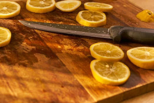 Slices of organic lemon on a wooden cutting board photo