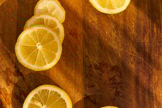 Slices of organic lemon on a wooden cutting board photo