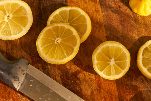 Slices of organic lemon on a wooden cutting board photo