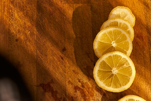 Slices of organic lemon on a wooden cutting board photo