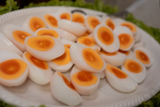 Halves of a boiled egg, a hard boiled egg cut in half on big dish photo