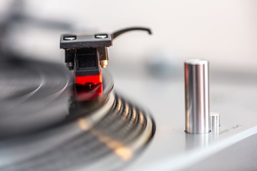 Close Up of Vinyl Record Playing on Turntable in Bright Setting photo