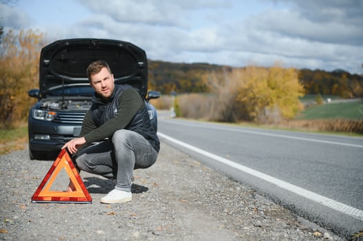 Man with broken car in the middle of the road. photo