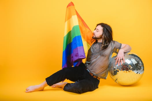 Young gay man is standing in the studio and posing for a camera. photo