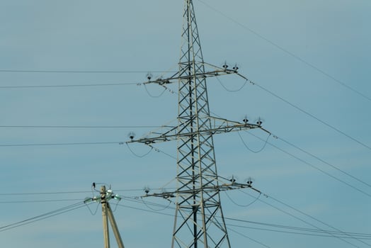High voltage towers with sky background. Power line support with wires for electricity transmission. High voltage grid tower with wire cable at distribution station. Energy industry, energy saving photo