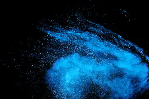 Blue Powder Explosion on Black Background, Dust Particles in Motion photo