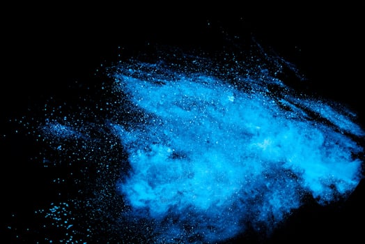 Blue Powder Explosion on Black Background, Dust Particles in Motion photo