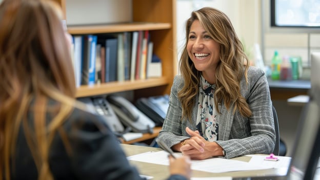 Happy woman at desk with laptop photo