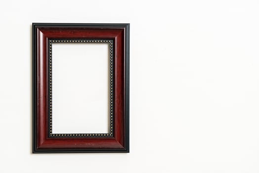 empty picture frame on white wall background photo