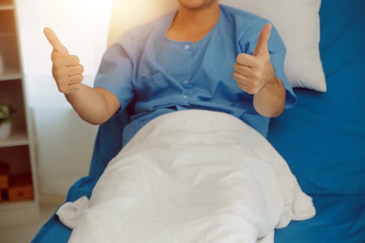 Portrait of happy caucasian sick patient on bed in hospital in medical and healthcare treatment at nursing home or clinic. People lifestyle photo