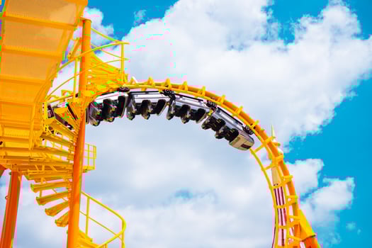 Yellow Roller coaster Roll loop curve high to blue sky summer season activity funny at amusement park. photo
