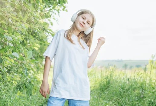 A child with headphones listening to music and dancing photo