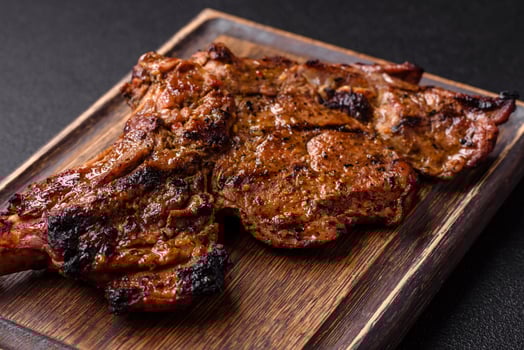 Juicy beef tomahawk steak on the bone baked on the grill photo