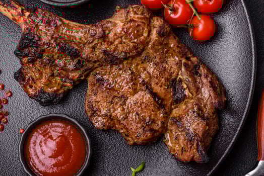 Juicy beef tomahawk steak on the bone baked on the grill photo