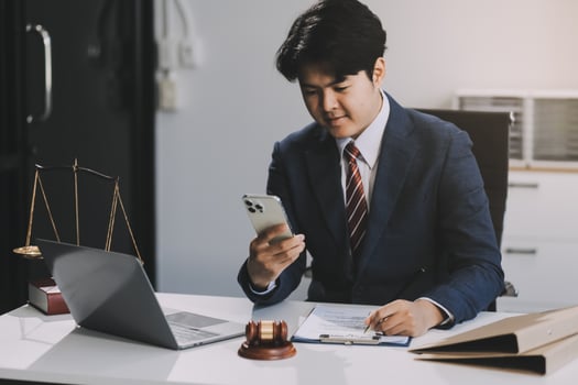 Male lawyer working with contract papers and wooden gavel on tabel in courtroom. justice and law ,attorney, court judge, concept. photo