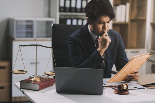 Male lawyer working with contract papers and wooden gavel on tabel in courtroom. justice and law ,attorney, court judge, concept. photo