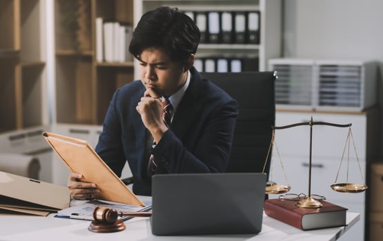 Male lawyer working with contract papers and wooden gavel on tabel in courtroom. justice and law ,attorney, court judge, concept. photo