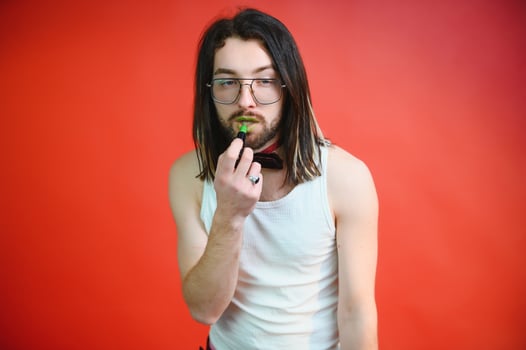 Young, handsome gay man on a colored background in the studio. LGBT concept. photo