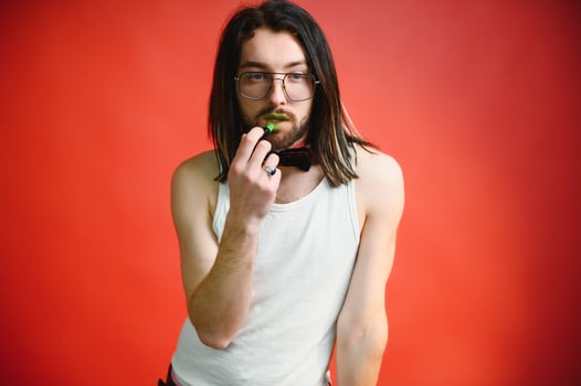 Gay man on a colored background in the studio. The concept of the LGBTQ community. Equality. photo
