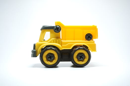 Yellow truck toy isolated on white background. photo