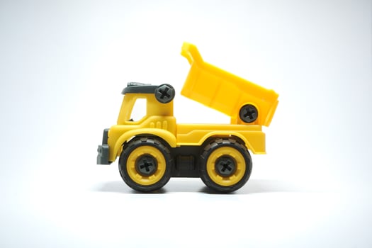 Yellow truck toy isolated on white background. photo