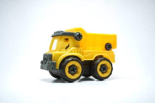 Yellow truck toy isolated on white background. photo