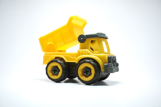 Yellow truck toy isolated on white background. photo