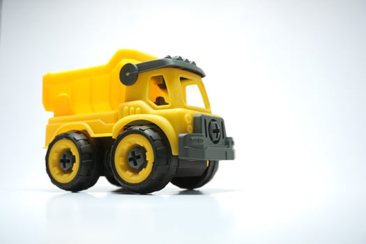 Yellow truck toy isolated on white background. photo