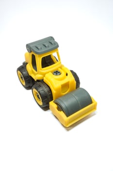 yellow tendem roller toy on white background. Tandem roller or road roller toy for kids photo