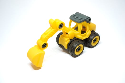Kids excavator toys. Yellow mini excavator for children learning photo
