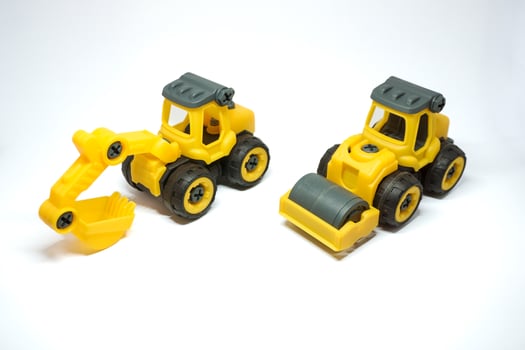 yellow excavator and tandem roller toys isolated on white background. kids excavator and tendem roller for kids photo