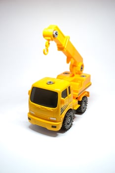 Yellow truck crane isolated on white. Truck crane for kids photo