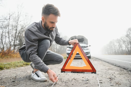 Sad man near broken car searching help in field photo
