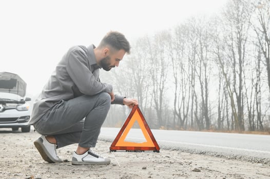 Sad man on the road next to the broken car photo