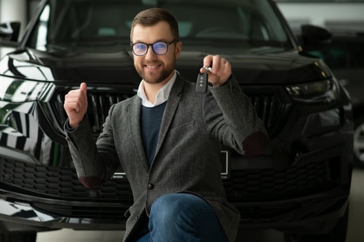 Young man with the keys at the car photo