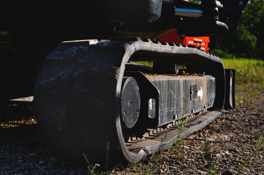 Rubber track shoes of a small excavator close-up photo