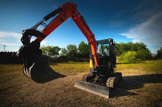 Close-up wide angle image of an excavator working on an agricultural farm in a forest belt photo