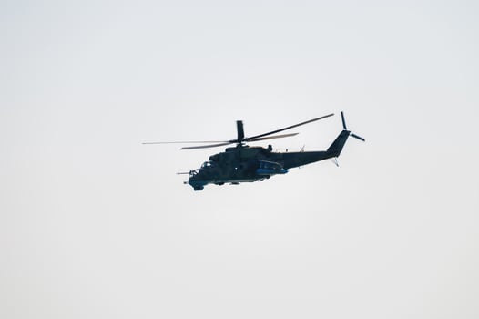 Military helicopter in clear skies. Unmarked helicopter photo