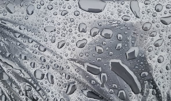 Large raindrops on a black trash bag photo