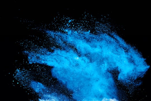 High-speed Capture of Blue Powder Explosion on Black Background photo