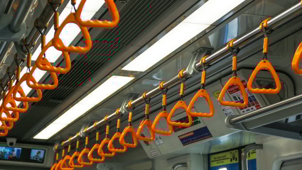 This is a close-up view of some of the yellow passenger handles located inside an LRT train car. photo