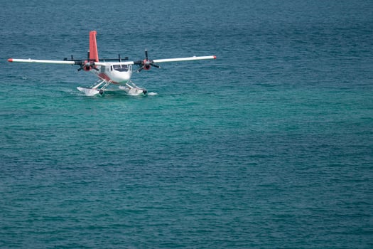 Seaplanes floating dock at Male airport, seaplanes in ocean lagoon. photo