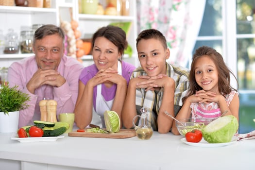 Portrait of beautiful family cooking at kitchen photo