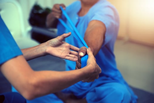Professional physical therapist examines and cares for a young man in a physical therapy center, treating muscles and injuries of a man in a hospital. photo