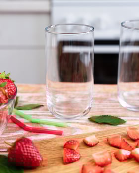 Empty glasses on the table in the kitchen for strawberry lemonade. Making lemonade with strawberries. Selective focus. photo