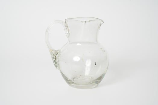 Glass carafe on white background photo