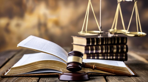 A law book, gavel and pair of scales on a table. Concept of justice for all and fair jury trial photo