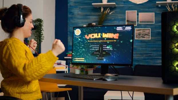Exciting professional esport gamer celebrates championship victory. Woman winning space shooter game. Online cyber gaming tournament live streaming event using technology network wireless photo