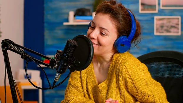 Woman recording on camera in home studio. Blogger, social media influencer sharing experience, on-air online production internet broadcast show host streaming live content for social media photo